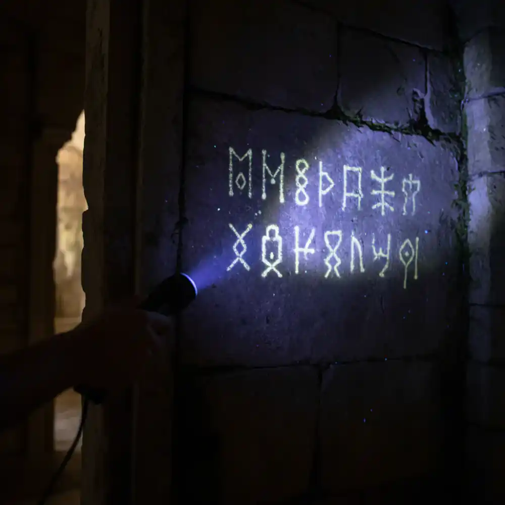 UV light revealing hidden text on a wall
